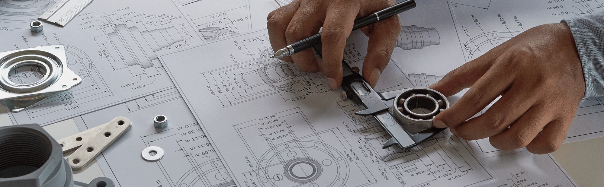 Man's hand looking over design plans