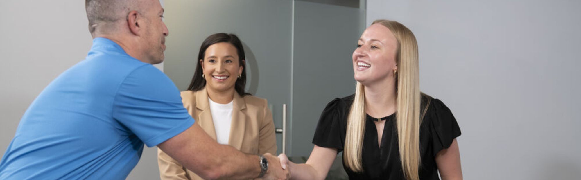 Business woman shaking hands with man interviewing for job at Palmer Group